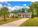 Single-story home featuring manicured landscaping, a new roof, and a covered carport at 508 W Hogle Ave, Deland, FL 32720