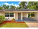 Exterior shot of a single-story home with a covered carport and nicely landscaped walkway at 508 W Hogle Ave, Deland, FL 32720