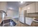 Close-up of the kitchen featuring granite countertops, white cabinets and stainless steel fixtures at 508 W Hogle Ave, Deland, FL 32720