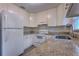 Bright kitchen featuring white cabinets, granite countertops, and stainless steel fixtures at 508 W Hogle Ave, Deland, FL 32720