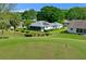 Aerial view of a single-story home with solar panels backing onto a golf course at 5097 Nw 19Th Pl, Ocala, FL 34482