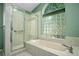 Ensuite bathroom with tub, shower and glass block window at 5097 Nw 19Th Pl, Ocala, FL 34482