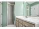 Bathroom featuring a single sink vanity, updated fixtures, a walk-in shower and coordinating mirror and light fixture at 5097 Nw 19Th Pl, Ocala, FL 34482