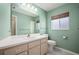 Bright bathroom featuring a single sink vanity, updated fixtures, and a coordinating mirror and light fixture at 5097 Nw 19Th Pl, Ocala, FL 34482
