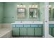 Ensuite bathroom features double sinks, tub, and a linen closet at 5097 Nw 19Th Pl, Ocala, FL 34482