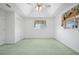 Spacious bedroom featuring a tray ceiling, neutral paint, plush carpet, and bright natural light at 5097 Nw 19Th Pl, Ocala, FL 34482