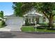 Charming single-story home with a well-manicured lawn, mature trees, and a two-car garage at 5097 Nw 19Th Pl, Ocala, FL 34482