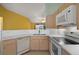 Functional kitchen featuring white appliances and a sink with a view for efficient meal preparation at 5097 Nw 19Th Pl, Ocala, FL 34482