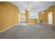 Spacious living room featuring a neutral color palette and ceiling fan, flowing layout, and natural light at 5097 Nw 19Th Pl, Ocala, FL 34482