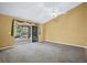 Bright living room with carpet, ceiling fan, and access to the screened patio with beautiful outdoor views at 5097 Nw 19Th Pl, Ocala, FL 34482