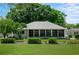 Single-story home with a large screened-in lanai and well manicured landscaping at 5097 Nw 19Th Pl, Ocala, FL 34482