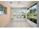 Inviting sunroom with tile floors, floor-to-ceiling windows, and an abundance of natural light overlooking the lush yard at 5097 Nw 19Th Pl, Ocala, FL 34482