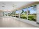 Inviting sunroom with tile floors, floor-to-ceiling windows, and an abundance of natural light overlooking the lush yard at 5097 Nw 19Th Pl, Ocala, FL 34482