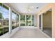 Inviting sunroom with tile floors, floor-to-ceiling windows, and an abundance of natural light overlooking the lush yard at 5097 Nw 19Th Pl, Ocala, FL 34482
