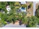 Aerial view of home, showcasing the pool, outdoor spaces, solar panels and lush landscaping at 510 E Wisconsin Ave, Orange City, FL 32763