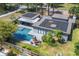 Aerial view of the modern home, highlighting the pool, outdoor space and solar panels at 510 E Wisconsin Ave, Orange City, FL 32763