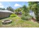 This is a spacious backyard featuring a table with umbrella and a fire pit area. Great for relaxing! at 510 E Wisconsin Ave, Orange City, FL 32763