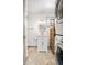 Charming half bathroom featuring a vanity and stacked washer and dryer at 510 E Wisconsin Ave, Orange City, FL 32763