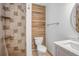 Renovated bathroom with walk-in shower, tile surround, and wooden accent wall at 510 E Wisconsin Ave, Orange City, FL 32763