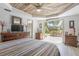 Bedroom with wood plank ceiling with patio access and ample natural light at 510 E Wisconsin Ave, Orange City, FL 32763
