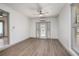 Bright bedroom featuring modern ceiling fan, neutral paint, and light wood-look flooring at 510 E Wisconsin Ave, Orange City, FL 32763