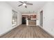 Open kitchen featuring wood style flooring, breakfast bar and stainless steel appliances at 510 E Wisconsin Ave, Orange City, FL 32763
