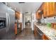 Galley kitchen boasting stainless steel appliances, granite counters, and ample cabinet space at 510 E Wisconsin Ave, Orange City, FL 32763