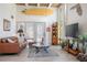 Stylish living room with large windows, surfboard decor, and cozy leather furniture at 510 E Wisconsin Ave, Orange City, FL 32763