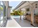 Outdoor kitchen area overlooking pool with a built-in grill and wooden bar at 510 E Wisconsin Ave, Orange City, FL 32763