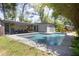 Well-maintained swimming pool surrounded by lush foliage and shade trees at 510 E Wisconsin Ave, Orange City, FL 32763