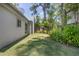 Secluded side yard with manicured lawn, offering a serene escape and natural privacy at 510 E Wisconsin Ave, Orange City, FL 32763