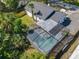 Aerial view showcasing the screened-in pool, backyard, and the house's roof in its entirety at 5400 Turton Ln, Port Orange, FL 32127