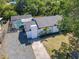 Aerial view of home with pool, mature landscaping, and a long driveway to the side at 5400 Turton Ln, Port Orange, FL 32127