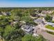 The property's aerial view captures its location within a lush neighborhood and screened-in pool at 5400 Turton Ln, Port Orange, FL 32127