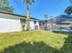 The backyard includes a screened-in pool and verdant grass, enhancing the home's outdoor appeal at 5400 Turton Ln, Port Orange, FL 32127