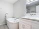 Modern bathroom with a freestanding soaking tub, dual vanity sinks, and stylish fixtures at 5400 Turton Ln, Port Orange, FL 32127