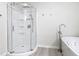 Bright bathroom featuring a walk-in shower with glass doors and a separate soaking tub at 5400 Turton Ln, Port Orange, FL 32127