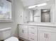 This bathroom features a large white vanity with a large mirror and chrome fixtures at 5400 Turton Ln, Port Orange, FL 32127