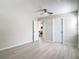 This bedroom features light gray walls, a ceiling fan, a window, and modern gray vinyl flooring at 5400 Turton Ln, Port Orange, FL 32127