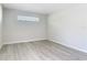 This bedroom features light gray walls, a window, and modern gray vinyl flooring at 5400 Turton Ln, Port Orange, FL 32127