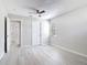 This bedroom features light gray walls, a ceiling fan, a window, and modern gray vinyl flooring at 5400 Turton Ln, Port Orange, FL 32127