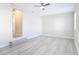 This bonus room features light gray walls, a ceiling fan, a window, and modern gray vinyl flooring at 5400 Turton Ln, Port Orange, FL 32127