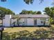 Charming single-story home with a white exterior, tidy landscaping, and a well-maintained lawn at 5400 Turton Ln, Port Orange, FL 32127
