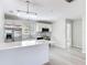 Modern kitchen featuring white cabinets, stainless appliances, and stylish geometric backsplash at 5400 Turton Ln, Port Orange, FL 32127
