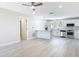 Spacious living room with open concept kitchen with stainless steel appliances and new floors at 5400 Turton Ln, Port Orange, FL 32127