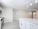 View of eat-in kitchen opening into living room with whitewashed fireplace and luxury vinyl floors at 5400 Turton Ln, Port Orange, FL 32127