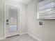Mudroom area with a window, exterior door, and convenient hookups for laundry appliances at 5400 Turton Ln, Port Orange, FL 32127