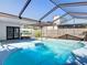 Beautiful backyard pool surrounded by a screened enclosure, patio, and fencing at 5400 Turton Ln, Port Orange, FL 32127