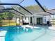 Inviting backyard pool with a screened enclosure and an outdoor living area at 5400 Turton Ln, Port Orange, FL 32127