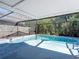 Backyard pool with a screened enclosure, providing a private and refreshing outdoor space at 5400 Turton Ln, Port Orange, FL 32127
